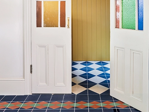 orange-blue-green-harlequin-cement-tiles-hallway-floor